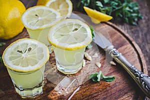 Italian traditional liqueur limoncello with lemon