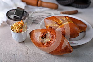 Traditional homemade pies with cabbage and sauerkraut on the plate