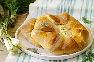 Traditional homemade Romanian and Moldovan pies - Placinta, served with wine. Rustic style.