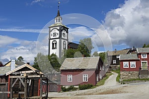 Traditional houses and church bell tower exterior of the copper mines town of Roros, Norway.