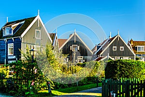 Traditional houses with green boarded wall and red tile roof in the small historic fishing village of Marken