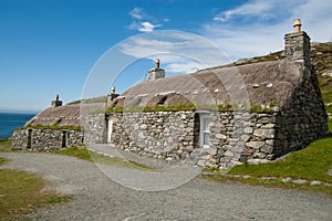 Traditional houses in an highland Scottish village. Gearrannan restored black houses, Isle of Lewis, Outer Hebrides. photo