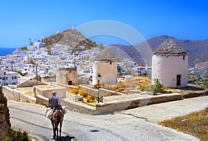 Traditional houses, wind mills and churches in Ios island, Cyclades.