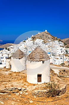 Traditional houses, wind mills and churches in Ios island, Cyclades, Greece.