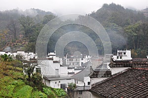 Traditional Hui style architecture in a foggy day in Wuyuan County-Jiangxi province-China