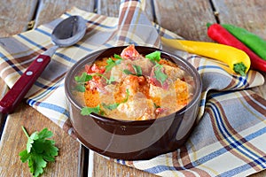 Traditional Hungarian dish witth paprika and chicken in a creamy sause In a ceramic pot. Healthy eating concept.