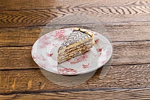 Traditional Hungarian Esterhazy cake with almond and chocolate  on wooden background