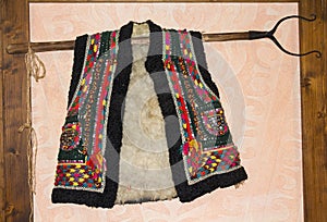 Traditional hutsul sheepskin vest hanging on the wall