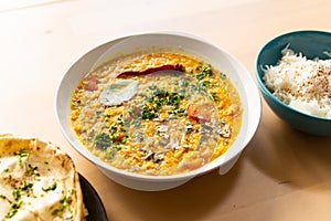 Traditional indian dal homemade. Traditional Indian soup lentils. Indian Dhal spicy curry in bowl with coriander and spices on