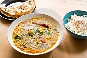 Traditional indian dal homemade. Traditional Indian soup lentils. Indian Dhal spicy curry in bowl with coriander and spices on