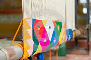 Traditional indian dari or carpet being woven on a manual loom