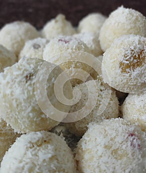 Traditional Indian dessert coconut balls / nariyal ladoos filled with lots of raisins photo