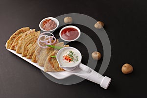 Traditional Indian food Aloo paratha or potato stuffed flat bread. served with pickle