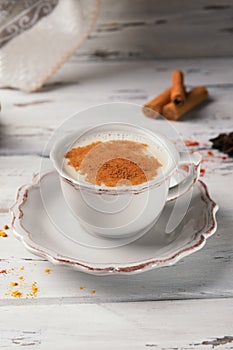 Traditional indian hot drink masala tea with spices on wooden background with ingredients