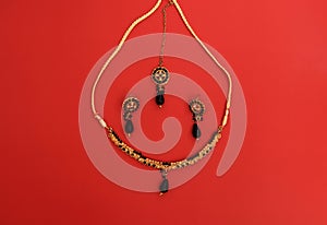 Traditional Indian jewelry is gold with black gems. Necklace, earrings, tika