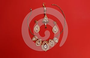 Traditional Indian jewelry is gold with gems. Necklace, earrings, tika