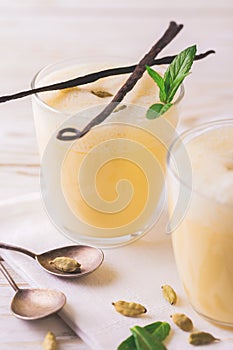 Traditional Indian mango lassi with cardamon, mint, vanilla and