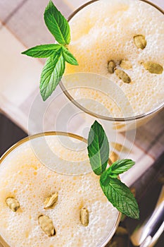 Traditional Indian mango lassi with cardamon, mint, vanilla and