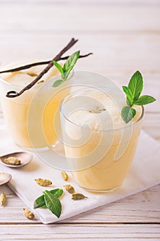 Traditional Indian mango lassi with cardamon, mint, vanilla and