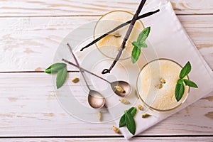 Traditional Indian mango lassi with cardamon, mint, vanilla and