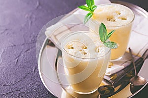 Traditional Indian mango lassi with cardamon, mint, vanilla and