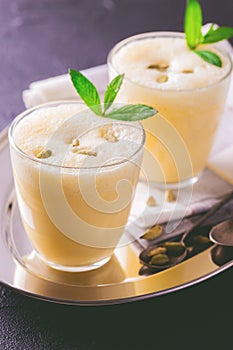 Traditional Indian mango lassi with cardamon, mint, vanilla and