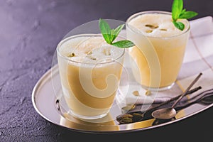 Traditional Indian mango lassi with cardamon, mint, vanilla and