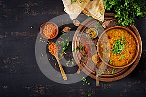 Traditional Indian soup lentils. Indian Dhal spicy curry in bowl, spices, herbs
