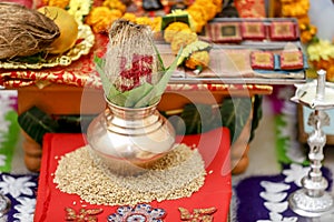 Traditional indian wedding ceremony: coconut in decorative coper kalash