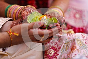 Traditional indian wedding ceremony, groom holding bride hand