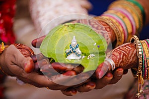 Traditional indian wedding ceremony, groom holding bride hand