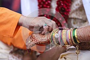 Traditional indian wedding ceremony, groom holding bride hand