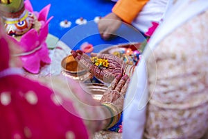 Traditional indian wedding ceremony, groom holding bride hand