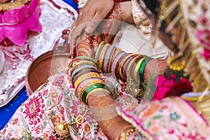 Traditional indian wedding ceremony, groom holding bride hand