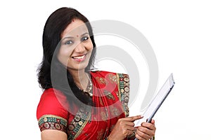 Traditional Indian woman holding a laptop computer