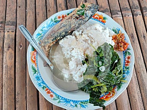 Traditional Indonesian breakfast menu on a floral patterned plate.