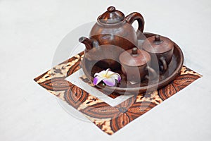 Traditional Indonesian tea set or teh poci for serving javanese black tea. Consists of a pot  cups and a tray made of clay.