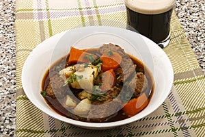 Traditional irish beef and guinness stew with carrot and fresh p photo