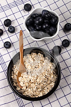 Traditional irish raw oatmeal in a black bowl