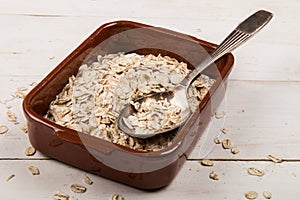 Traditional irish raw oatmeal in a brown bowl