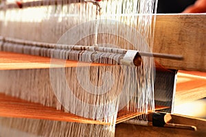 Traditional Isan Thai cotton weaving. The weaving cotton in traditional way at manual loom. Buriram, Thailand