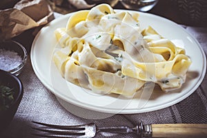 Traditional Italian Alfredo Pasta Plate with Creamy Cheese and Basil Sauce