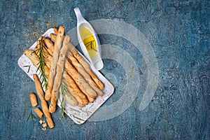 Traditional italian appetizer grissini with rosemary spice and olive oil