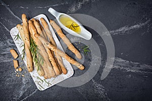 Traditional italian appetizer grissini with rosemary spice and olive oil