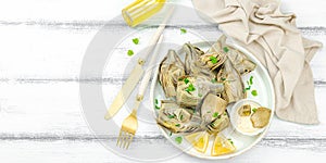 Traditional italian artichoke Â«alla romanaÂ», cooked carciofi vegetable. Olive oil, garlic, parsley