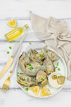 Traditional italian artichoke Â«alla romanaÂ», cooked carciofi vegetable. Olive oil, garlic, parsley