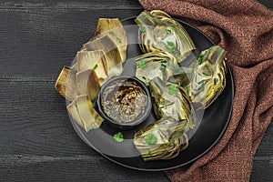 Traditional italian artichoke Â«alla romanaÂ», cooked carciofi vegetable. Olive oil, garlic, parsley