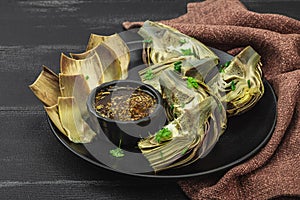 Traditional italian artichoke Â«alla romanaÂ», cooked carciofi vegetable. Olive oil, garlic, parsley