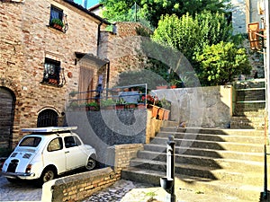 Traditional Italian atmosphere. Vintage Fiat 500 car, cat and light