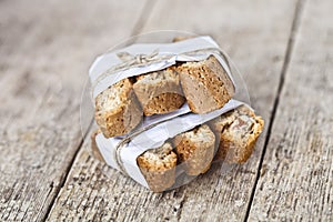 Traditional Italian cookies cantuccini wid almonds on white paper on ructic wooden table background